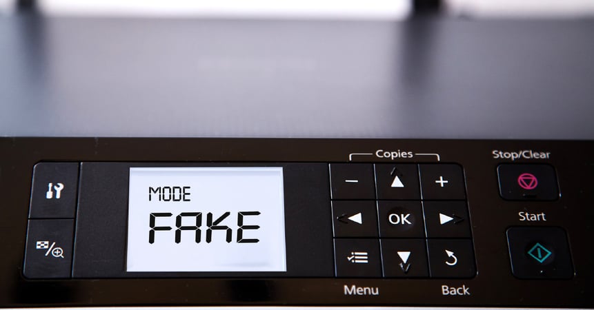 A printer displays that it is in "Fake" mode to illustrate common office printer myths that are no longer true.