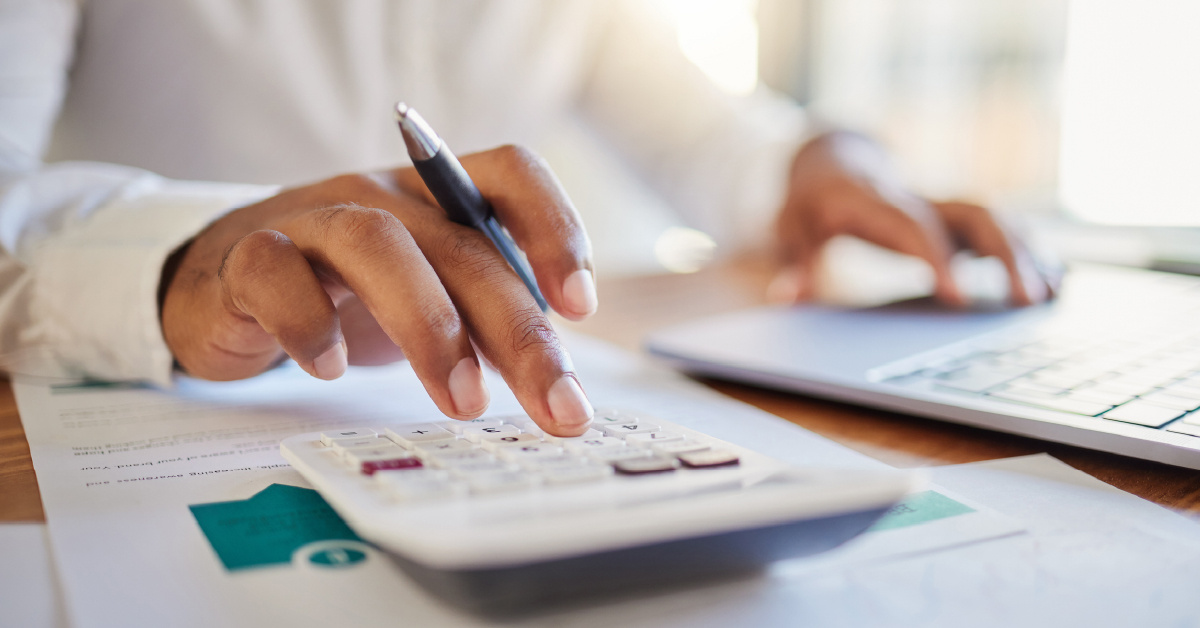 An employee uses a calculator to make sure that managed IT will bring them the ROI they need.