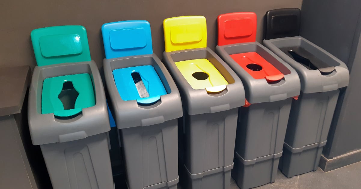 Recycling ink and toner cartridges available at many big box stores alongside recycling bins for metal and plastic.